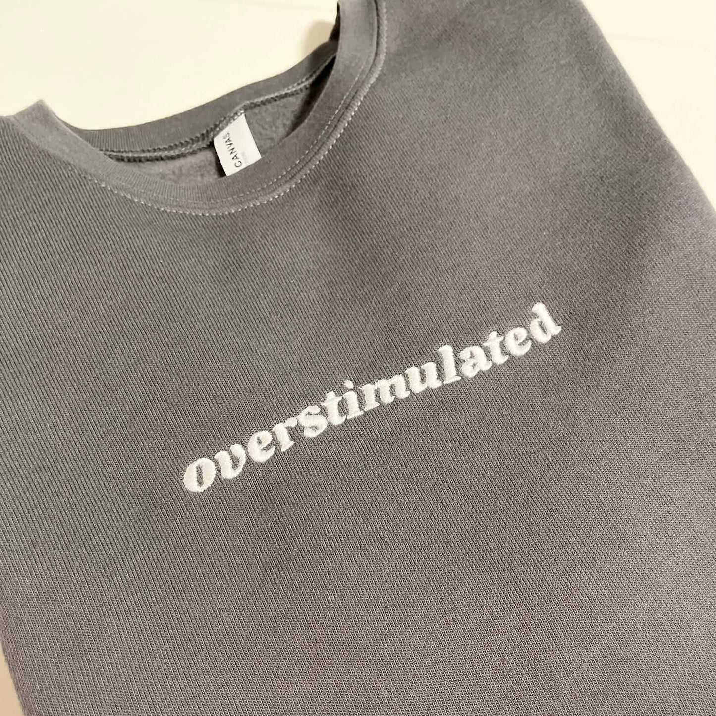 Overstimulated Embroidered Sweatshirt  - Dark Grey with White Text