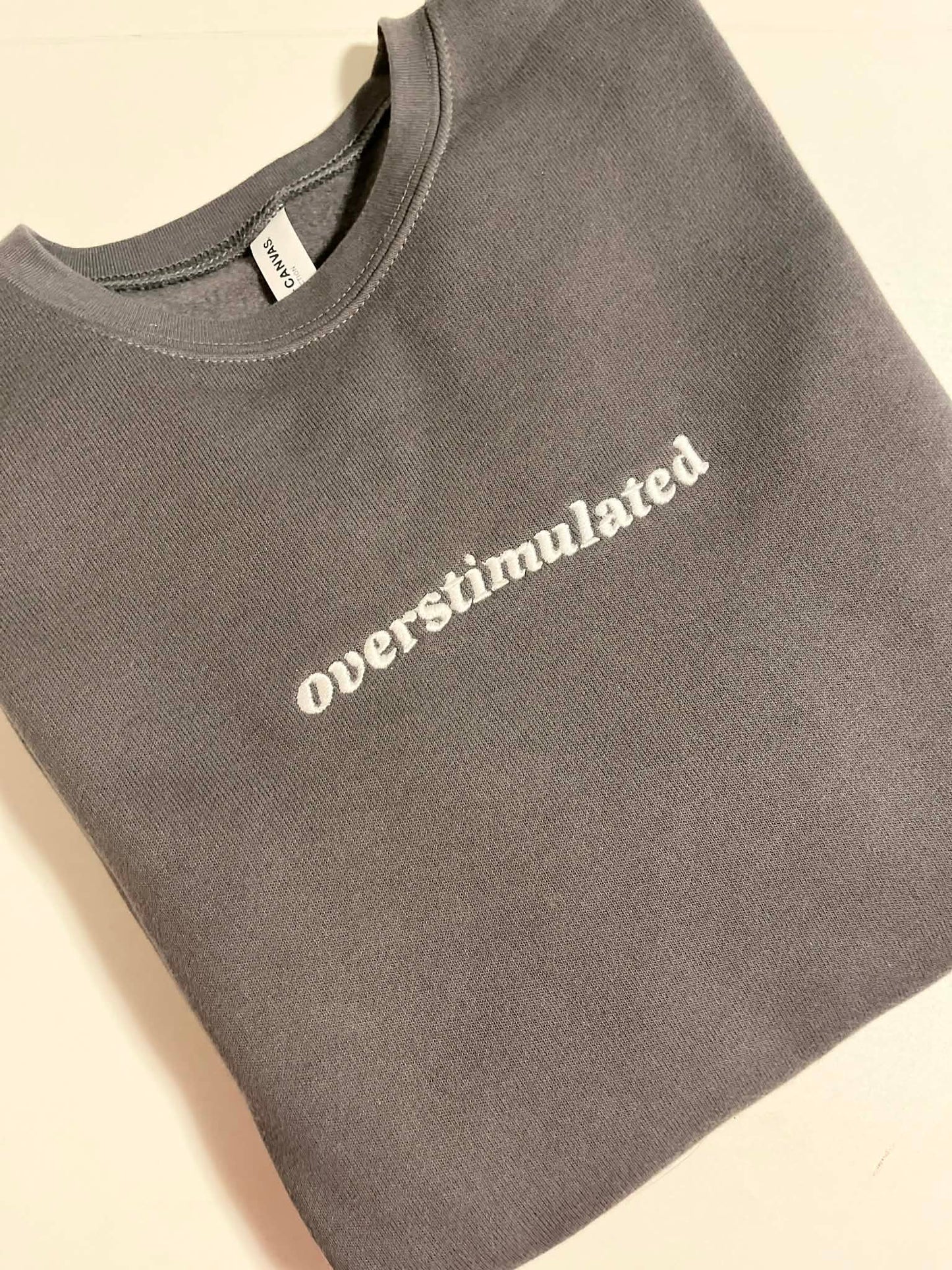 Overstimulated Embroidered Sweatshirt  - Dark Grey with White Text
